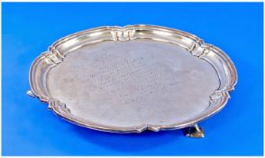 A Circular Silver Salver with piecrust borders supported on 3 hoofed feet. Inscribed to centre.