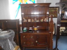 Early 20th Century Oak Dresser with Rack, the rack with two shelves, the base with door and two