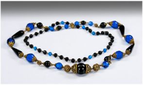 Long Black and Blue 1930`s Necklace, comprising black round and teardrop beads and Royal blue