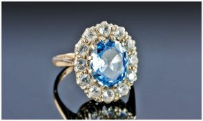 Vintage 1920`s Diamond and Aquamarine Cluster Ring. The central oval aquamarine surrounded by 12