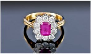 18ct Gold Ruby & Diamond Cluster Ring the step cut ruby surrounded by 10 diamonds. A fine pigeon