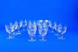 Set of 16 Cut Glass Drinking Glasses, the bowls with diamond and sun burst cut decoration, knopped