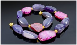 Necklace consisting of ten Amethyst coloured polished stones, interspersed between four pink Quartz