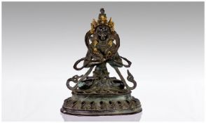 A Sino-Tibetan Cast Bronze Deity Figure with Parcel Gilding.  20th Century. Height 17.5 cm.