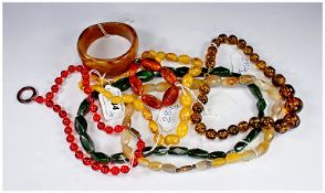 Small Collection of Bead Jewellery comprising three amber coloured necklaces, a bracelet and bangle