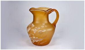 A Cameo Style 1920`s Glass Jug with raised floral decoration on orange ground. 8 inches high.