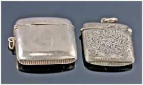 Two Various Silver Vesta Cases, comprising one with scrolled engraving and shield shaped vacant