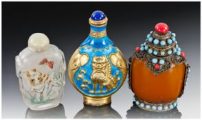 A Chinese Amber Glass Snuff Bottle with metal mounts and glass bead decoration, an inside painted