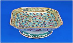 Chinese Lobed/Square Form Footed Dish, hand decorated with two circling dragons amongst the clouds