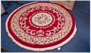 Circular Woolen Rug, symmetrically patterned floral decoration on a red ground, 51 inches high.