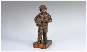 Small cast bronze coloured Newspaper boy signed `Speshul`. This lttle statue measures around 18 cm