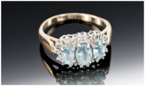 14ct Gold Dress Ring, Set With Three Central Light Blue Gemstones Surrounded By 22 Round Cut