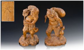 An Extremely Fine Quality Pair Of Japanese Carved Boxwood, Okimmos, one depicting an Omi with a