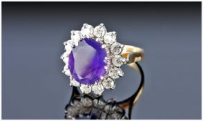 18ct Gold Set Amethyst and Diamond Ring. The large single stone amethyst of good colour, surrounded