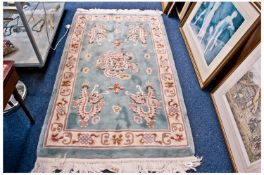 Small Chinese Style Woolen Rug, with dragon motif decoration to centre, with cream edge, on a green