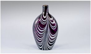 An Eighteenth Century Nailsea Glass Flask decorated with milky white swirls on an amethyst body. 7.