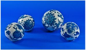 Four Chinese Twentieth Century Porcelain Carpet Boules, each enamelled in blue with typical