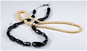 Whitby Jet Strand and Ivory Necklace, the jet being of faceted cabochon form, flat back and domed
