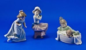 Three Various Nao Figures of Young Girls, each with a dog, one seated, one running and the other