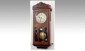 Oak 1920`s H.A.G. Wall Clock, moulded top, the glazed door opening to reveal silvered dial with