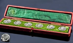 Cased Set of Six Art Nouveau Silver Buttons, each of scrolling floral form with a fitted case.