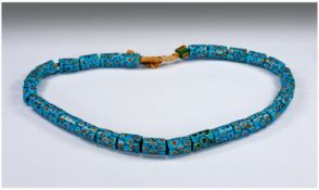 Strand of African Trade Beads, predominantly turquoise with honeycomb pattern tubes and red and