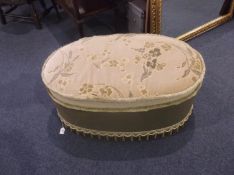 Small Upholstered Pouffe, the seat opening up to reveal storage section.