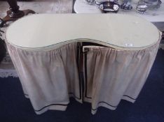 Small Kidney Shaped Dressing Table, fitted with two sections, the doors in cloth, opening to reveal