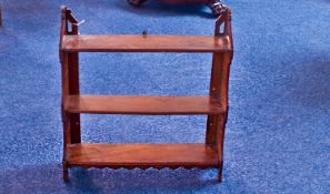 Late Victorian Walnut Wall Hanging Shelf, of three tier form, the sides with simple pierced