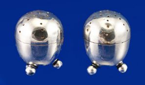 Edwardian Pair of Silver Egg Shaped Salt and Pepper Pots, each supported on three ball feet.