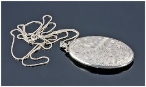 A Large Silver Oval Locket, supported on a long silver box chain. Locket 2.5 inches high, chain