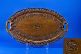 An Unusual Oval Carved Indian Snake Handled Teak Tray. Carved to the centre with the crest of the