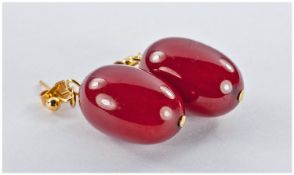Pair of Toffee Red Amber Drop Earrings, each opaque drop just under 1 inch long, with post and