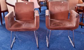 Pair of Retro Styled Lounge Chairs, upholstered in suade leather, raised on a continuous tubular