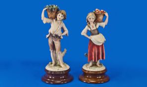 Capo Di Monte Signed Pair of Figures, A boy and girl carrying baskets of fruit dressed in early