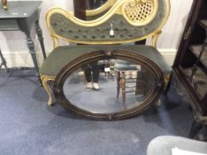 Early 20th Century Oak Oval Mirror, fitted with bevelled edge glass, applied moulded split