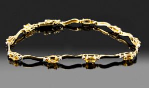 10ct Gold Line Bracelet, Set With Nine Oval Cut Citrines, Each Set Between Two Round Cut Diamonds.