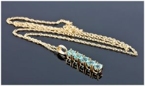 9ct Gold Blue Topaz Pendant, Suspended On A 9ct Gold Fine Link Chain, With Box.