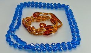 Two Strands Of Glass Beads, One Strand Of Round Faceted Blue Beads, Length 50 Inches. Together With