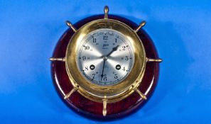 German Schatz ``Ship`s Bells`` Clock, Mounted On A Mahogany Plaque.