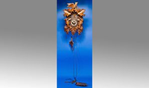 Swiss Cuckoo Clock with wood pendulum and 2 iron weights in the shape of pine cones. With a