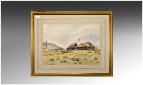 A Framed Watercolour Landscape with thatched roof cottages by Lakeland artist J Ingham Riley.