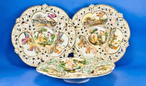 Pair and Single Capodimonte Decorative Dishes, the pair each centred with a polychrome scene of