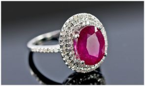 14ct White Gold Ruby & Diamond Ring, Set With An Oval Cut Ruby (Estimated Weight 4.75ct) Surrounded