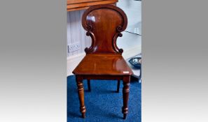 Mid Victorian Mahogany Hall Chair, the solid back with scrollwork to sides and indent to back,