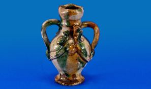 A Small Chinese Earthenware Vase of Sancai Glaze, with twin handles and applied moulded birds and