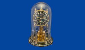 Late 20th Century Anniversary Clock, with glass dome, the face with brass Arabic numerals on a