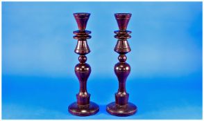 Pair of Turned Hardwood Candlesticks, with tapering sconces, shaped columns, raised on spreading