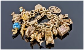 9ct Gold Vintage Charm Bracelet loaded with 21 good quality charms with safety chain & padlock. All