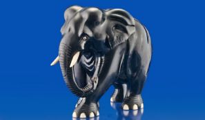 Ebony Early Twentieth Century Elephant Figure with ivory tusks and toes, 7.5 inches high.